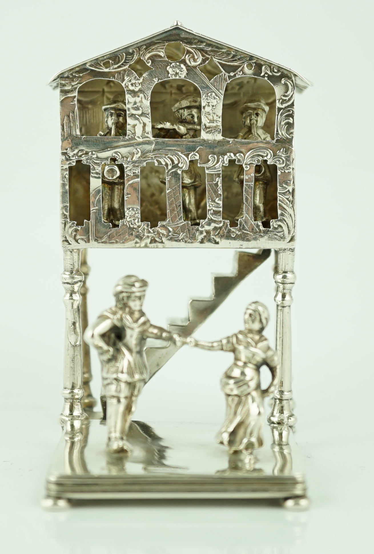 A late 19th century German silver miniature figural group, modelled as two dancers, with three musicians in a band stand, import marks for John George Smith